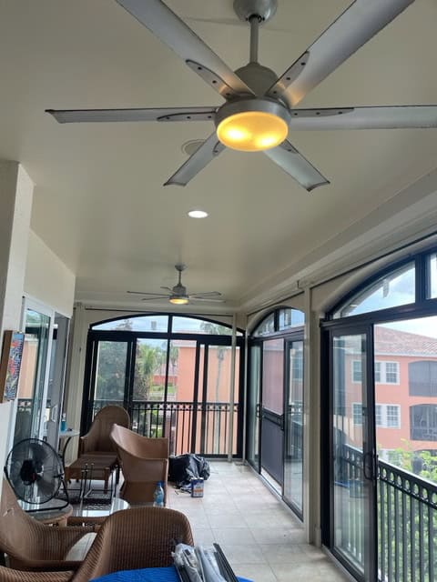 A lanai with multiple impact sliding doors and windows installed throughout.