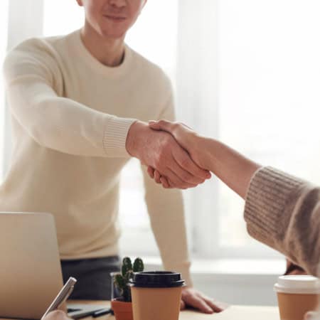 Man shaking a woman's hand.