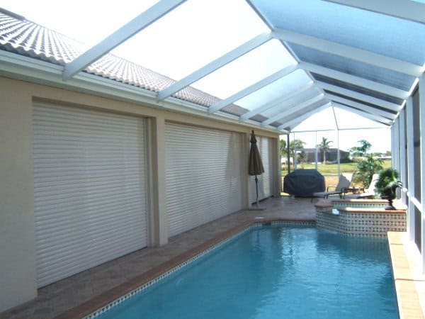 Roll down shutters covering the lanai of a home.