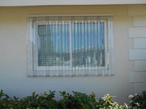 clear-storm-panels Clear, corrugated storm panels shown installed on a window
