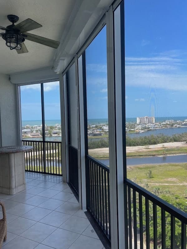 Balcony view facing the island with a line of hidden roll down shutters installed on a condominium in Fort Myers Beach Florida
