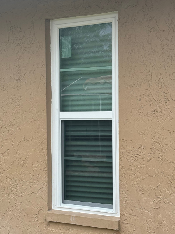 A single impact window with white vinyl frame.