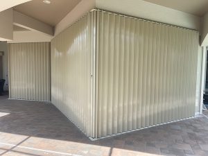 Tan accordion shutters on glass doors