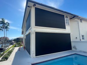 Black hurricane screens on patio and balcony of a two story home in Cape Coral.