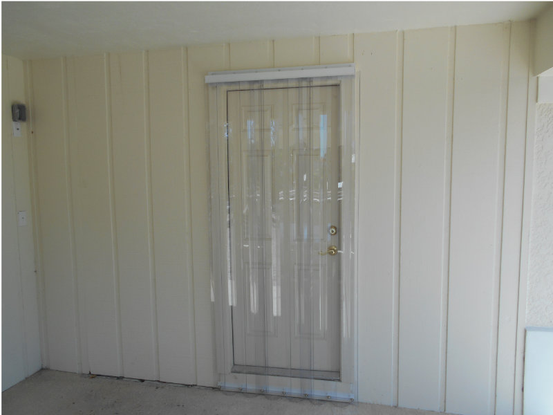 Polycarbonate storm panels installed on an entry door