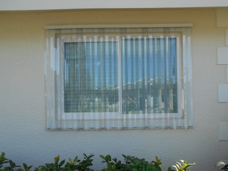 Polycarbonate storm panels installed on a window opening