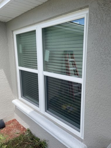Two double hung impact windows on a home