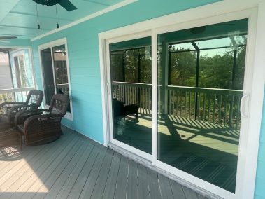 Impact windows and doors installed on a blue home