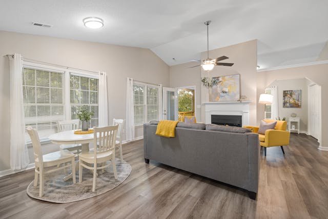 View of a living room with windows looking to the outside.