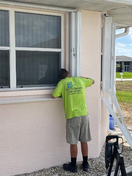 Technician inspecting shutters