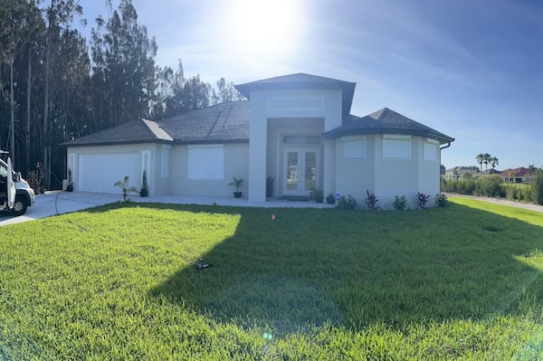 White retractable hurricane shutters on a home in Lehigh Acres