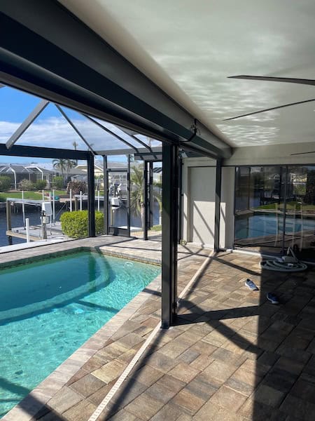 Bronze retractable hurricane shutters on a lanai