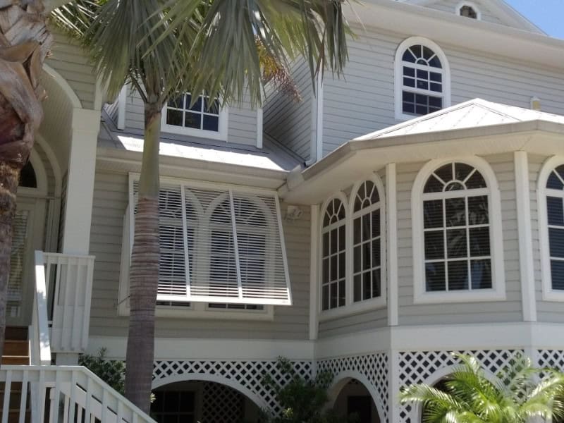White Bahama beach house shutters on a home in Fort Myers Beach Florida