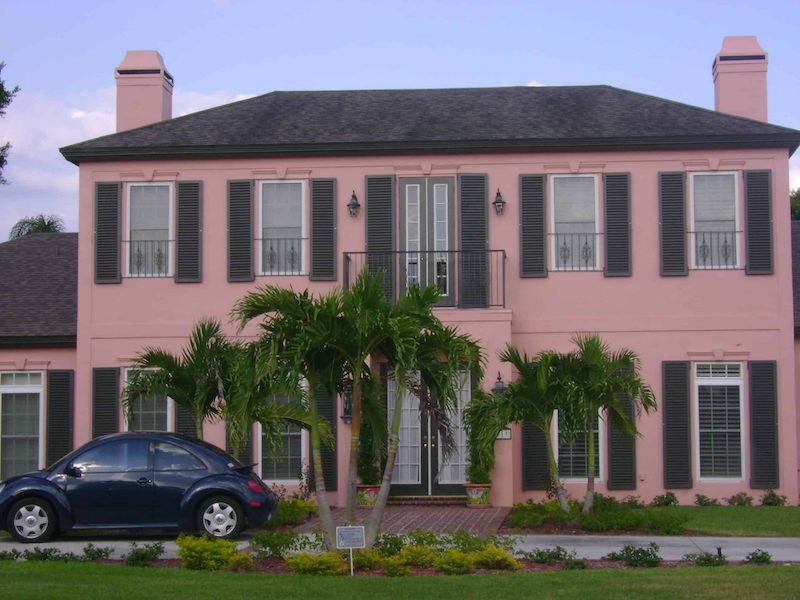 Colonial home in the British West-Indies variation, highlighted by salmon paint and Colonial Shutters.