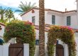 Mediterranean style home with palm trees.