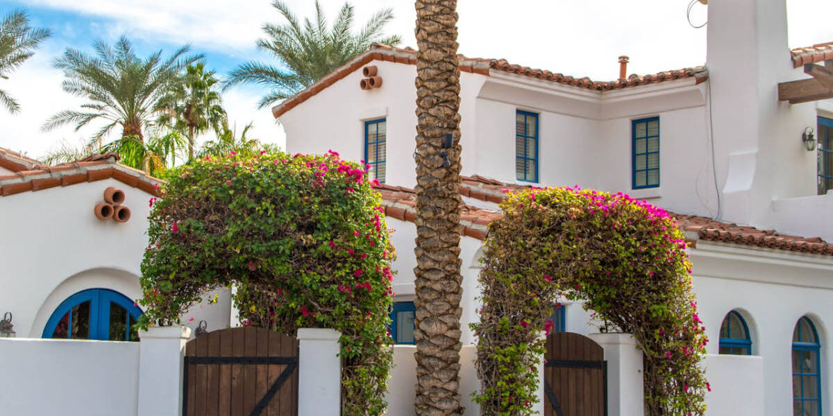 mediterranean-style-homes-storm-protection Mediterranean style home with palm trees.