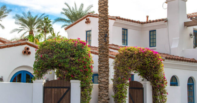 mediterranean-style-homes-storm-protection Mediterranean style home with palm trees.