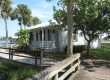 Old Florida-style home with extended roof, large patio, and colonial shutters.