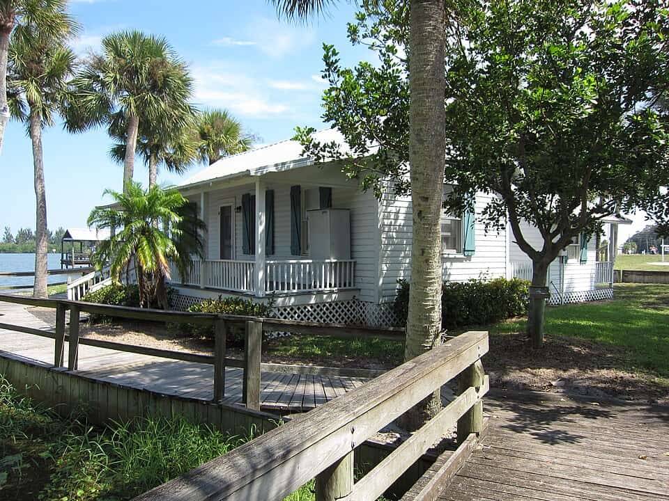 Old Florida-style home with extended roof, large patio, and colonial shutters.