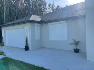 Roll down hurricane shutters on a ranch home in Lehigh Acres.