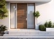 Impact front door of a white home with vegetation.